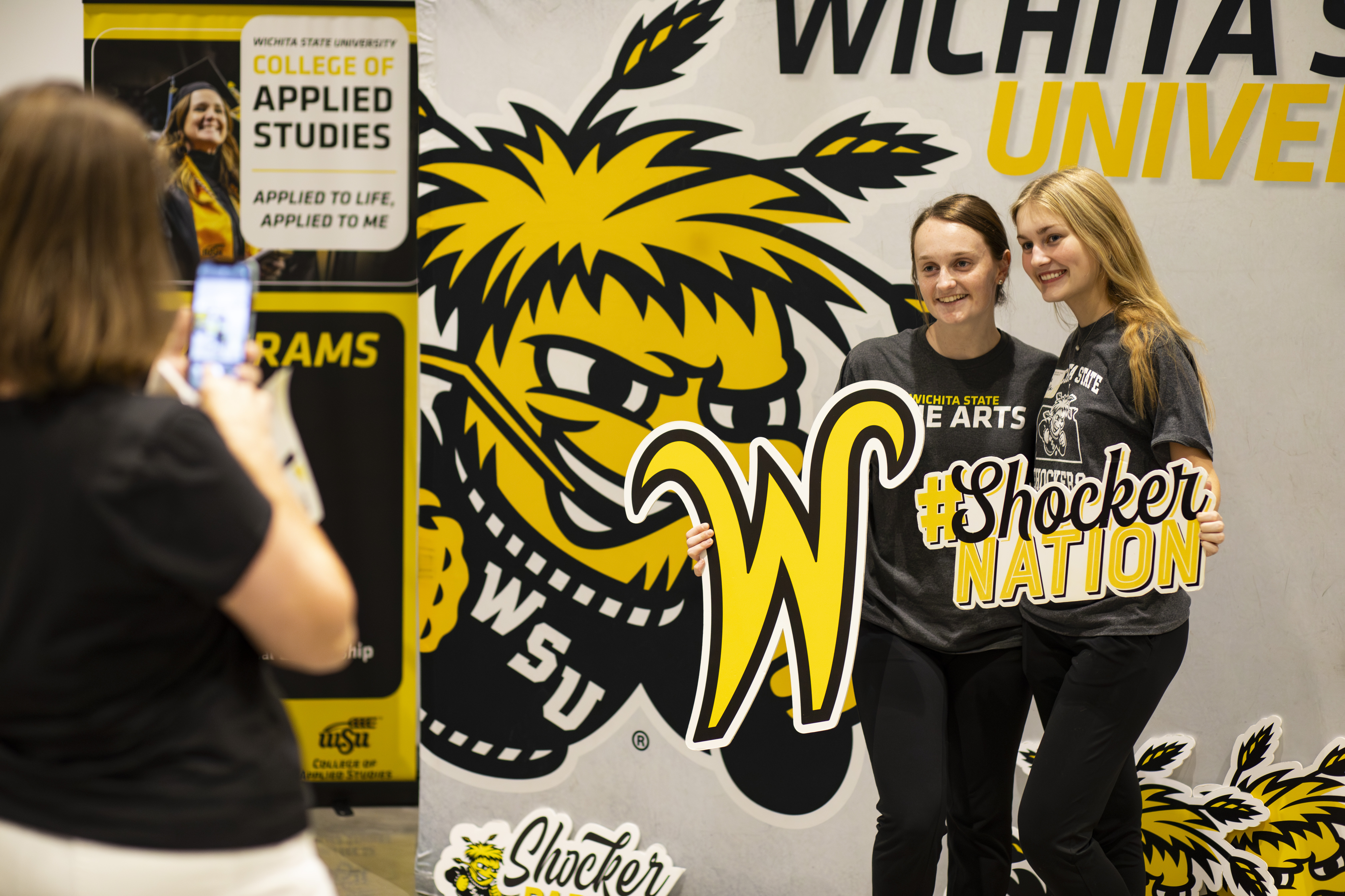 Student smiling getting their picture taken