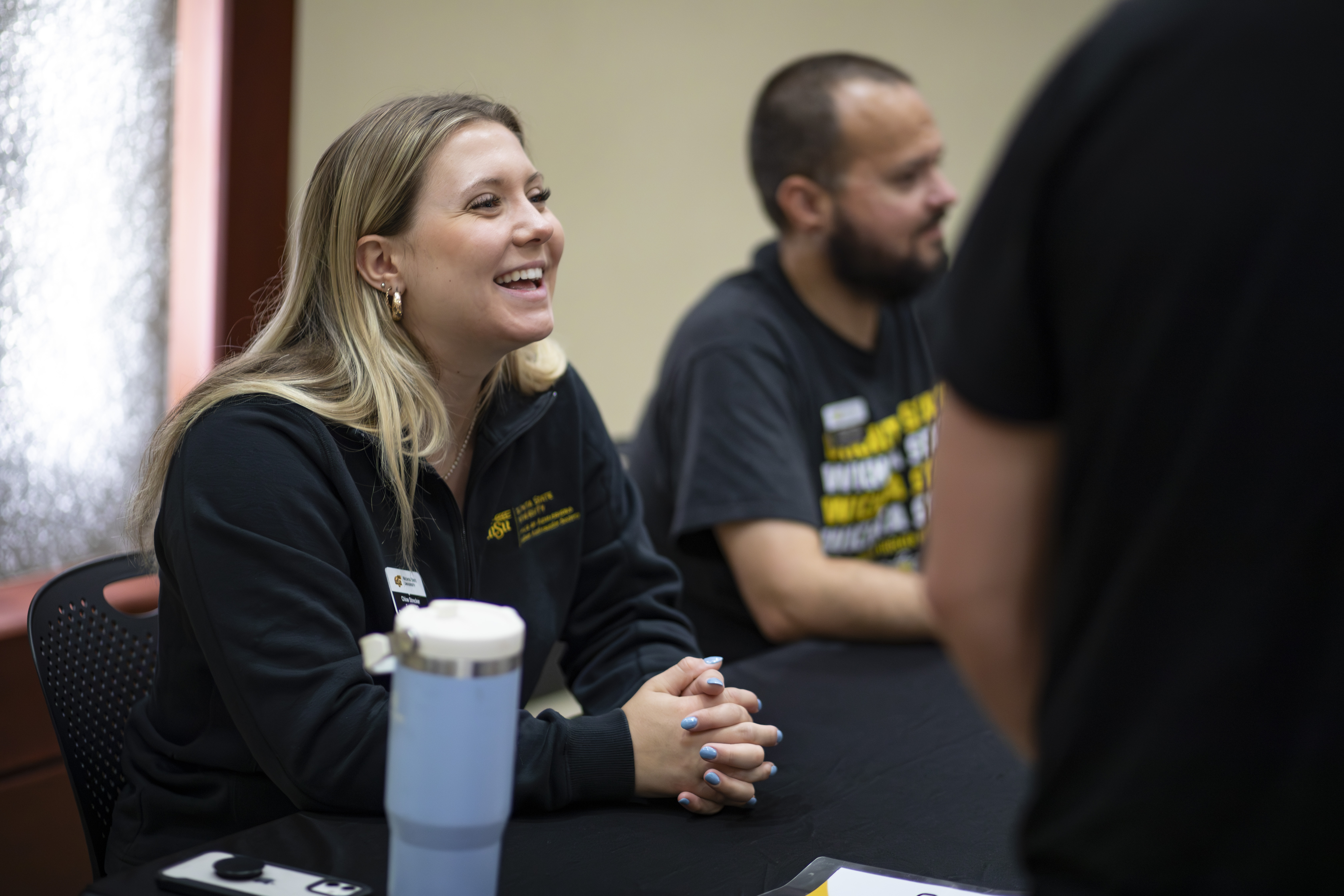 A current student smiling during the event