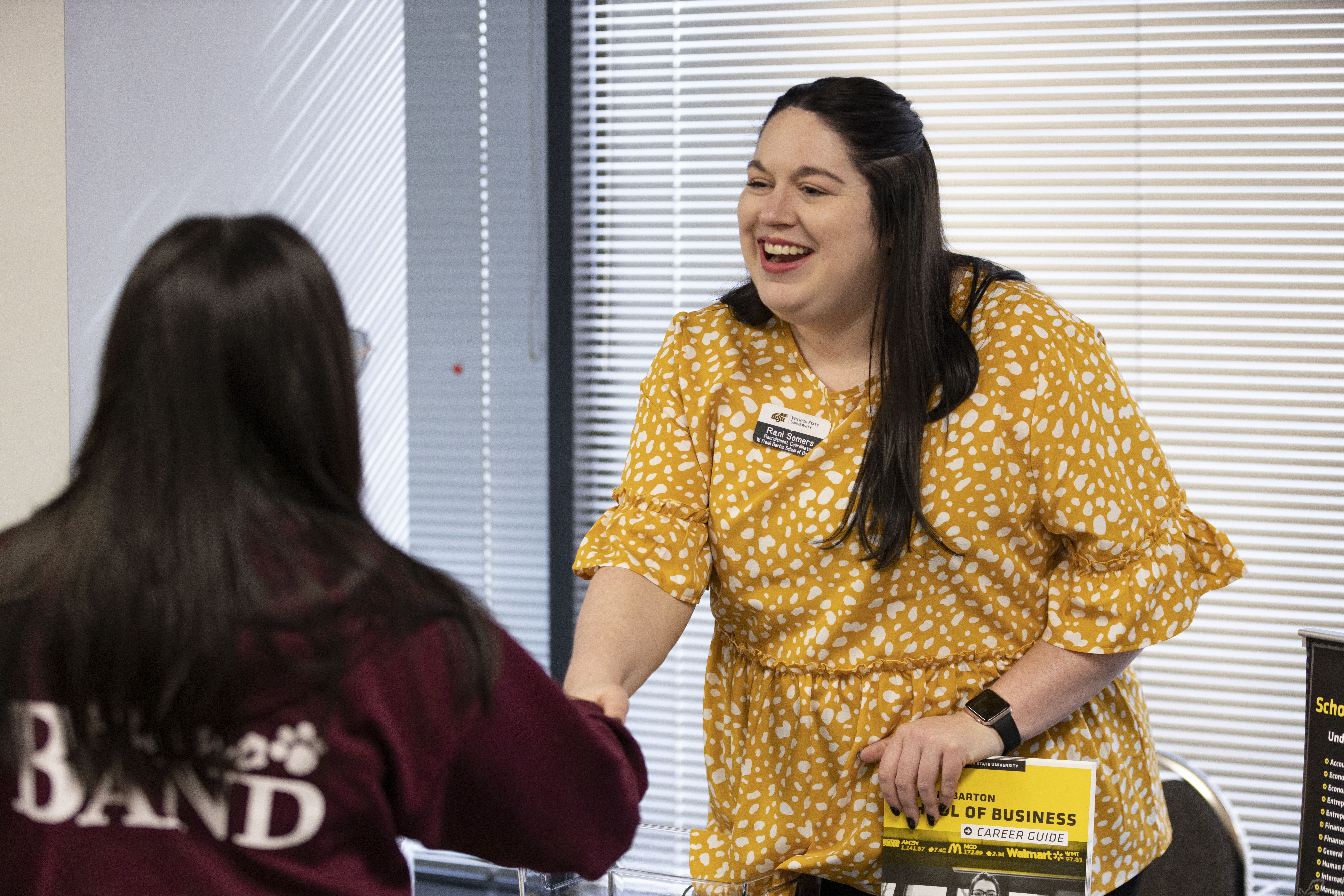 Wichita State staff shaking hands with a student